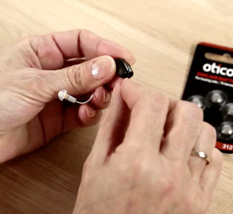 How to insert the battery in behind-the-ear hearing aids