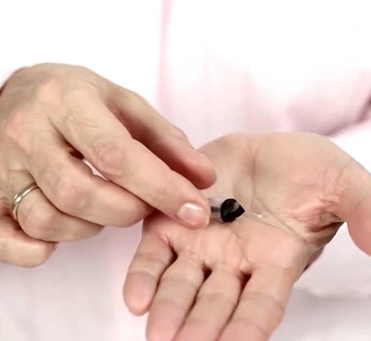 Inserting an IIC (invisible-in-the-canal) hearing aid